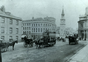 Horse-drawn vehicles in front of Derry's Clock in the 1900s