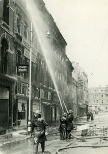 Firemen Hosing down bomb damage at Fred E Notcutt's in 1941